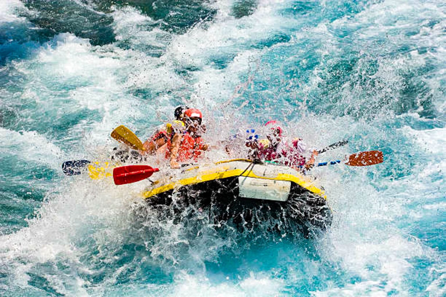 Kayaker paddling through blue water canyons